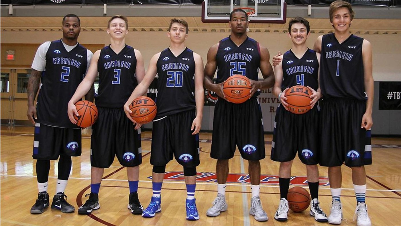The 2014 Eberlein Drive TBT team in black Eberlein jerseys, holding basketballs.