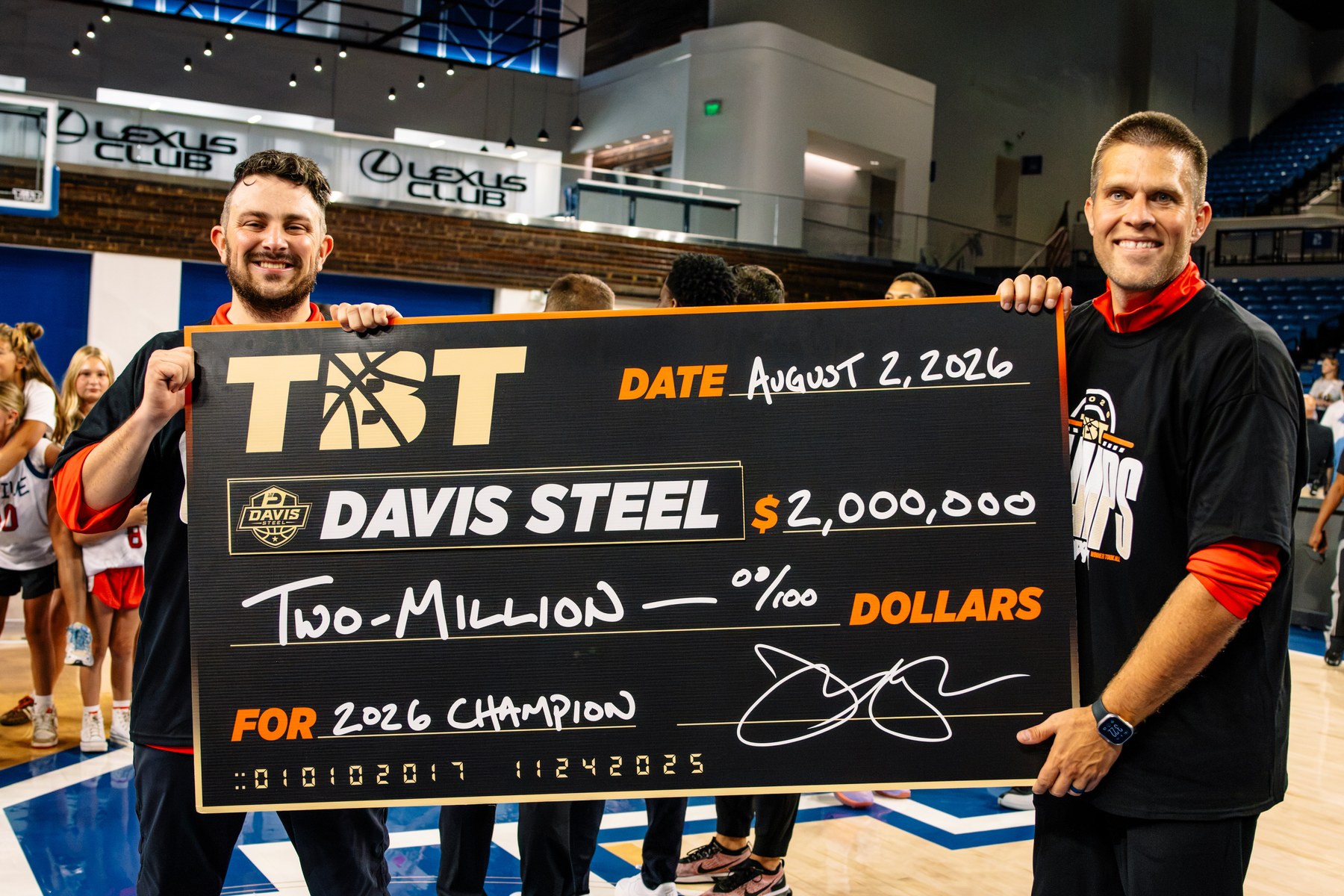 Matt Mitchell and Jake Hirschmann holding the $2,000,000 championship check